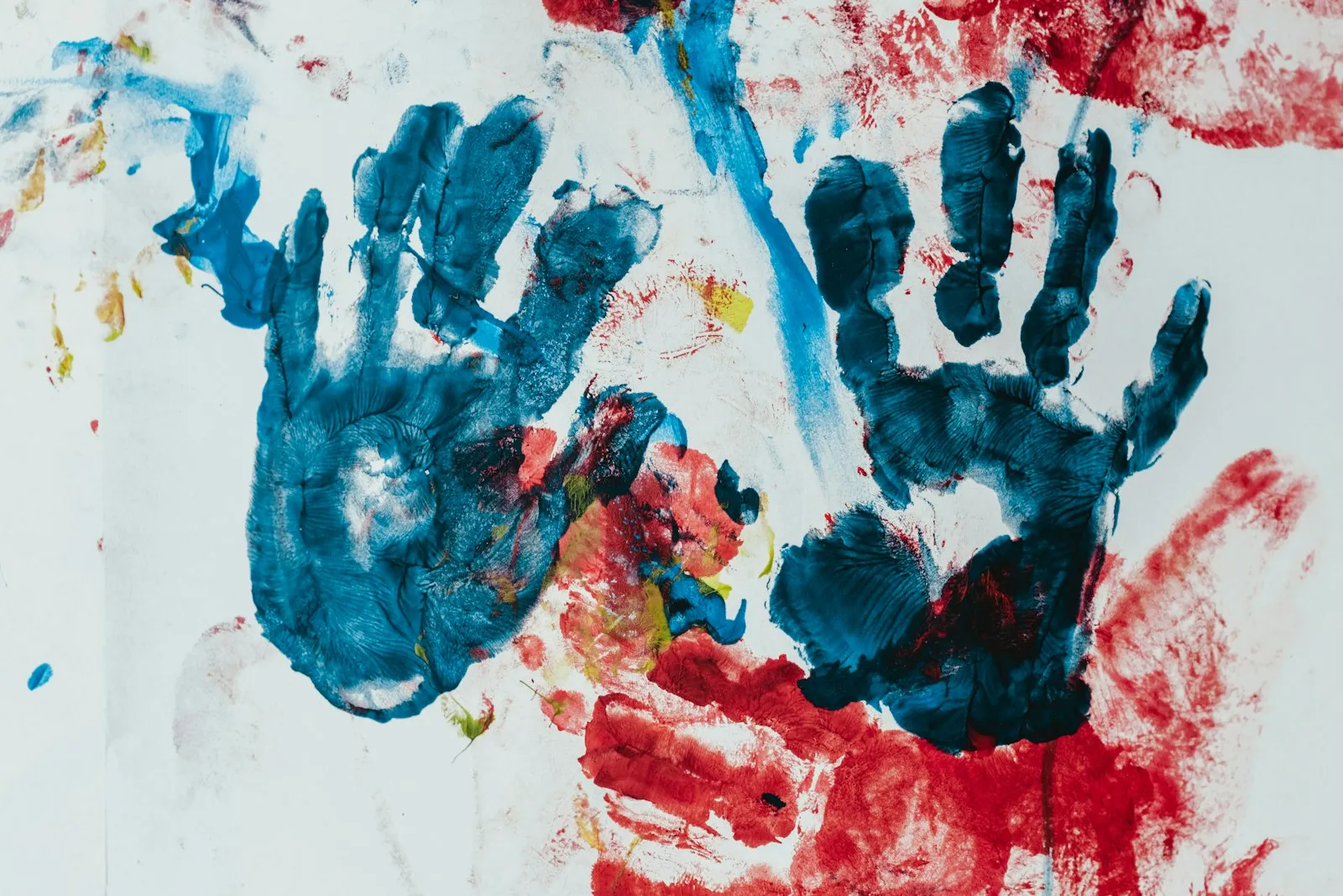 Colourful children’s handprints painted on paper